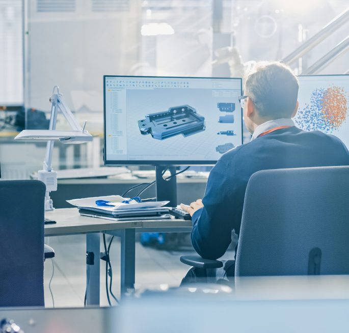 Back,View,Of,Industrial,Engineer,Working,On,Desktop,Computer,In